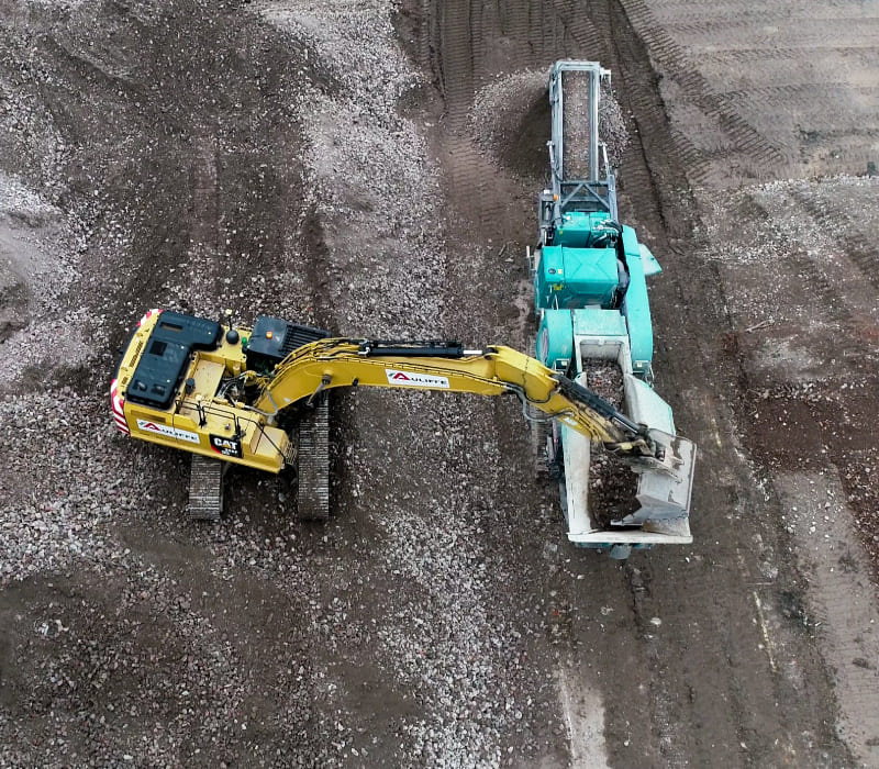 Aerial view of McAuliffe's remediation techniques involving heavy machinery to repurpose materials on site.